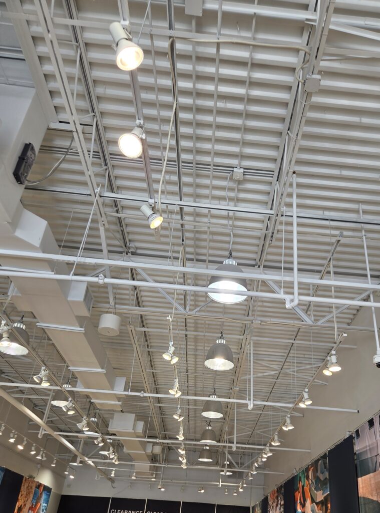 Ceiling of a commercial building with lighting and ventilation.